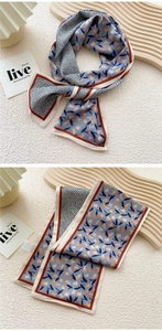 Detail of floral and geometric silk scarf displayed on a minimalist wooden prop