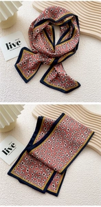 Detail of red floral skinny scarf with contrast navy and ginger yellow borders