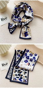 Detail view of double-sided silk twilly scarf with floral and leopard prints