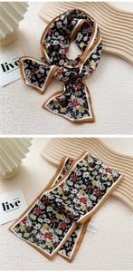 Detail of skinny silk scarf featuring daisy floral print and contrast color hem design