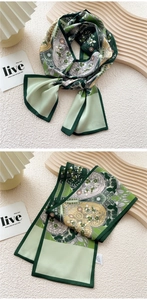 Detail of green floral silk scarf with paisley pattern on elegant textured background