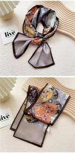 Detail of vintage paisley silk scarf styled as a hair ribbon on a wooden stand