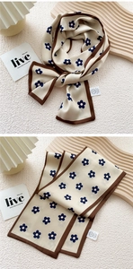 Detail of silk-like floral skinny scarf with navy flowers and elegant brown border