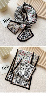 Detailed close-up of mixed pattern long silk scarf with zebra and floral print elements