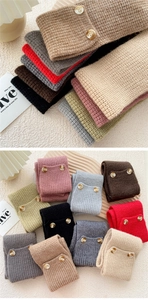 Detailed view of chunky knit neck warmers with decorative wood buttons in multiple colors