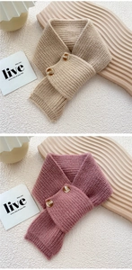 Detail view of khaki and pink knit scarves with textured buttons and thick yarn