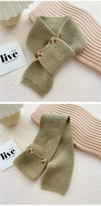 Close-up of green knitted scarf with ribbed texture and two brown vintage buttons