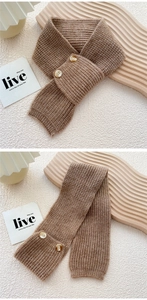 Close-up of a camel chunky knit scarf featuring a decorative double button closure
