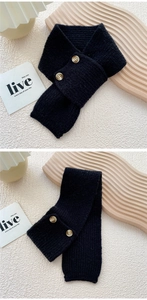 Detail of black knit neck warmer with double wooden buttons and warm texture
