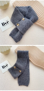 Detail of grey chunky knit scarf featuring two dark brown wooden buttons and wool texture
