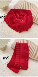 Detail of red knitted scarf with diamond texture and three decorative buttons