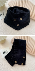 Detail of black knit scarf with three marble buttons and classic cable knit texture