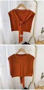 Detailed view of caramel knit shawl wrap with fine ribbed edges and soft cashmere-like texture