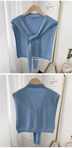 Detail of blue knitted shawl featuring a tie-up front and high-quality cashmere texture