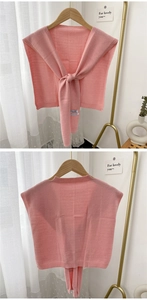 Front and back detail of a pink knit shawl wrap with ribbed edges and knot design