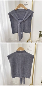Front and back views of a grey knitted shawl with lace-up front and ribbed edges