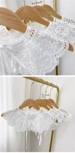 Detailed embroidery on white lace detachable collar showing intricate floral hollow patterns