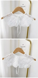 Detail of white hollow floral lace fake collar with embroidery and delicate ribbon ties