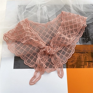 Detailed view of pink lace neckerchief with mesh embroidery and scalloped edges
