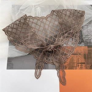 Close-up of brown lace lace-up decorative neck scarf with hollow embroidery detail