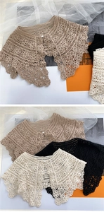 Detail of floral crochet lace shawl with pearl button in beige black and white