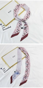 Detailed view of pink floral twilly scarf with wine red ends and 100% polyester texture