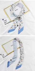 Detail of skinny floral scarf showing double-sided flower print and blue striped pattern