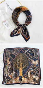 Detail of navy blue silk scarf with tree of life pattern and orange border