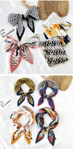 Detailed view of pleated silk scarves with geometric prints and zigzag edges displayed as bows