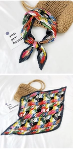 Detail of pleated silk scarf with colorful cartoon cat print and accordion fold design