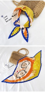 Detail of pleated silk scarf with colorful blocks and Snoopy cartoon character design