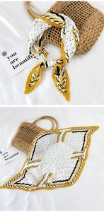 Detail of yellow pleated square scarf with polka dots and stripes on a straw bag