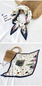 Detail of pleated silk square scarf with abstract navy and burgundy prints on white