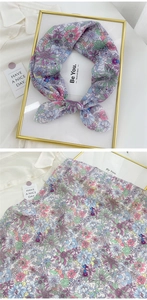 Detailed view of floral cotton linen neckerchief with pastel flower pattern and soft texture