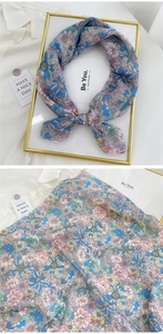 Detail of floral linen-cotton square scarf showing intricate blue and pink flower patterns