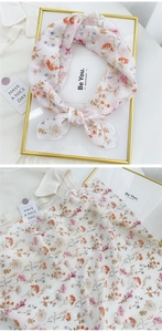 Floral cotton linen scarf detail with pink flower patterns and delicate rolled edges