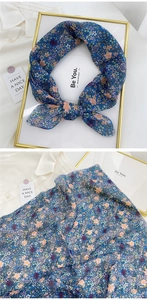 Detailed texture of dark blue floral cotton linen scarf with elegant small flower pattern