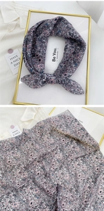 Detailed shot of floral cotton linen neckerchief with elegant knot and pattern texture