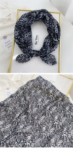 Close-up of semi-transparent floral linen-cotton scarf fabric with delicate black and white print