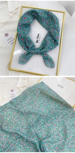 Detail of floral linen-cotton scarf showing delicate lake green pattern and fine hem work