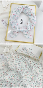 Detail view of light floral cotton linen scarf with elegant pink blossom patterns
