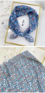 Detail of blue floral cotton linen scarf showing delicate print and soft thin texture
