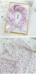 Detail of pink floral cotton linen scarf with blue daisy print and soft texture