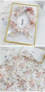Detail of floral linen silk scarf with butterfly print and lightweight fabric texture