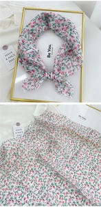 Detail of floral cotton linen neckerchief with pink flowers on a white background