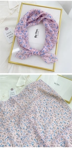 Detail of floral pink cotton linen neckerchief showing delicate fabric texture and pattern