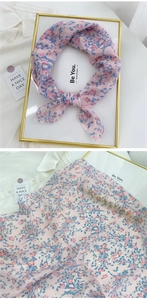 Detail of pink floral cotton linen scarf showing soft fabric texture and knotted style