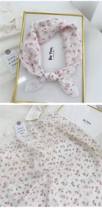 Detail of floral cotton linen square scarf showing fabric texture and knotted style