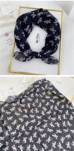 Detail of floral linen-cotton neck scarf featuring white and purple daisy print pattern