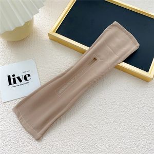 Close-up of khaki Deft Bun hair tool with flexible wire and premium fabric texture